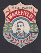 Trade card, W.N. Sharpe, shield shaped card, 'Well Played Wakefield' with D.G. Mackie inset (ex) (