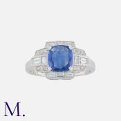 A Sapphire And Diamond Ring in 18k white gold, of geometric design, set with a central cushion cut