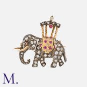 A French Ruby And Diamond Elephant Brooch in 18k yellow gold and silver, designed as an elephant set
