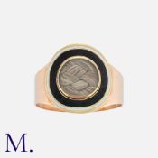 A Georgian Enamel Mourning Ring in yellow gold, comprising a central locket of woven hairwork within