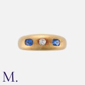 An Old Cut Diamond And Sapphire Three Stone Gypsy Ring in 18k yellow gold, set with a central old