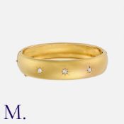 An Antique Old Cut Diamond Bangle in 18k yellow gold, the 15mm wide bangle set with three old cut