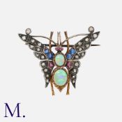 An Opal, Ruby, Sapphire And Diamond Brooch, in yellow gold and silver, designed as a butterfly, with