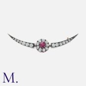 A Victorian Ruby And Diamond Crescent Brooch in yellow gold and silver, the old cut diamond crescent