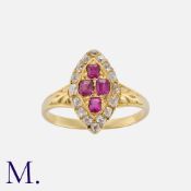 An Edwardian Ruby And Diamond Ring in yellow gold, the navette shaped face set with four cushion cut