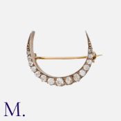 An Old Cut Diamond Crescent Brooch in silver and gold, set with old cut diamonds totalling