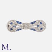 An Art Deco Sapphire and Diamond Brooch in platinum with a bow design, set with old-cut and eight-