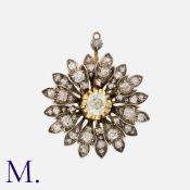 An Old Cut Diamond Pendant in yellow gold and silver, of floral design, set with a principal old cut