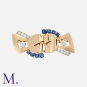A Retro Sapphire And Diamond Double Clip Brooch in yellow gold, comprising two clips, fastening to a