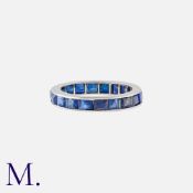 A Sapphire Eternity Ring in platinum, set all around with calibre cut sapphires. Unmarked, tests