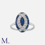 An Art Deco Sapphire and Diamond Ring in platinum, set with a marquise sapphire to the centre with