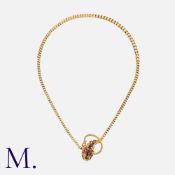 A Garnet Snake Necklace in yellow gold, the head of the snake set with eight cabochon garnets, to an