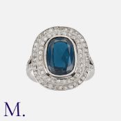 An Art Deco Spinel And Diamond Cluster Ring in platinum, set with a large cushion shaped spinel of