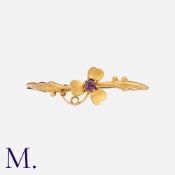 A Gem-Set Shamrock Brooch in yellow gold. Unmarked but tests indicate 9K gold. Metal pin.