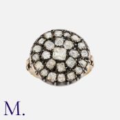 An Antique Button Ring in yellow gold and silver. The large circular face set old cut and table