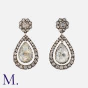 A Pair of Antique Rose Diamond Earrings in yellow gold and silver, each with a centre pendulum set