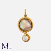 A Pearl And Diamond Pendant in yellow gold, set with a baroque pearl, within a scrolling gold