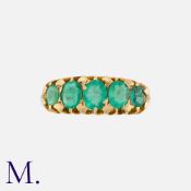 An Antique Emerald 5-Stone Ring in 18K yellow gold. Comprising five graduated oval cut emeralds.