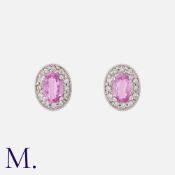 A Pair of Pink Sapphire and Diamond Earrings in 18K white gold, each set with an oval cut pink