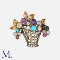 A Giardiniere Brooch in yellow and white metal set with various gemstones. Size: 3.4x4.0cm Weight: