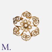 A Pearl Flower Brooch in yellow gold, set with pearls in round, openwork floral form. Unmarked;