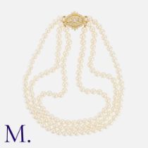 A Three Row Pearl Necklace in 18k yellow gold. Comprising three strands of pearls measuring from 6.