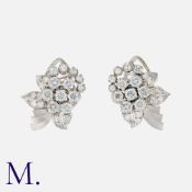 A Pair Of Diamond Clips in white gold, of floral design, set with round cut diamonds totalling