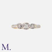 A Diamond 3-Stone Ring in yellow gold and platinum, set with three round cut diamonds weighing