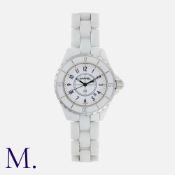 CHANEL. A Ladies J12 Wristwatch in white ceramic, quartz movement, the circular white lacquer dial