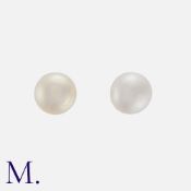 A Pair Of Pearl Stud Earrings in yellow gold, each compressing a pearl of approximately 6.2mm, to