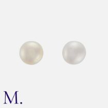 A Pair Of Pearl Stud Earrings in yellow gold, each compressing a pearl of approximately 6.2mm, to