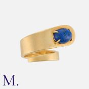 DINH VAN for CARTIER, A Lapis Lazuli Ring in 18k yellow gold, of coiled design, set with an oval