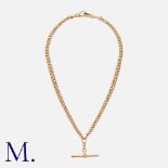 An Antique Albert Chain in 9K yellow gold with T-bar pendant and dog-clip fastenings. Stamped '9'