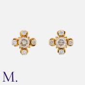 A Pair of Diamond Earrings in yellow gold set with round brilliant diamonds, the centre stones