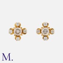 A Pair of Diamond Earrings in yellow gold set with round brilliant diamonds, the centre stones