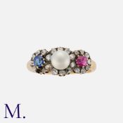 A Victorian Ruby, Pearl, Sapphire And Diamond Ring in yellow gold, set with a round cut ruby, a