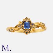 An Antique Synthetic Sapphire And Enamel Bangle in 18k yellow gold. Of scrolling and foliate design,
