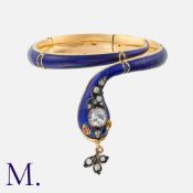 An Enamel Snake Bangle in 18k yellow gold. Set with rubies, diamonds and a white sapphire to the