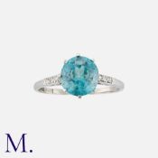 A Zircon And Diamond Ring in platinum, set with a round cut blue zircon of approximately 3.0ct,