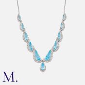 A Topaz And Diamond Necklace in 18k white gold, set with a series of mixed cut topaz and diamond set