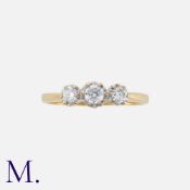 A Diamond Three Stone Ring in 18k yellow gold, set with three round cut diamonds totalling