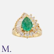 An Emerald and Diamond Ring in 18K yellow gold, set with a pear-cut emerald weighing approximately