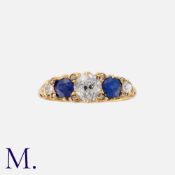 An Antique Sapphire And Diamond Five Stone Ring in 18k yellow gold, set centrally with an old cut