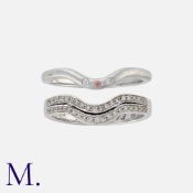 A Pair of Diamond 'Enhancer' Rings in 9K white gold. Ring one set with two rows of round cut