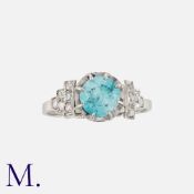 A Zircon And Diamond Ring in platinum, set with a round cut zircon of approximately 1.80ct, accented