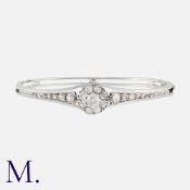 A Diamond Bangle in 18K white gold, set with old cut diamonds in a cluster to the centre (