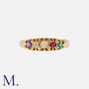 An Antique 'ADORE' Acrostic Ring in 18K yellow gold. Set with an amethyst, diamond, opal, ruby and