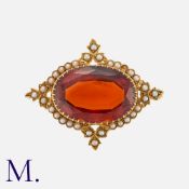 An Antique Garnet and Pearl Brooch in 15K yellow gold, set with a large oval almandine garnet (