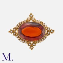 An Antique Garnet and Pearl Brooch in 15K yellow gold, set with a large oval almandine garnet (