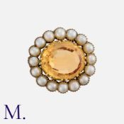 A Georgian Topaz and Pearl Cluster Brooch in yellow gold, set centrally with an oval cut topaz of
